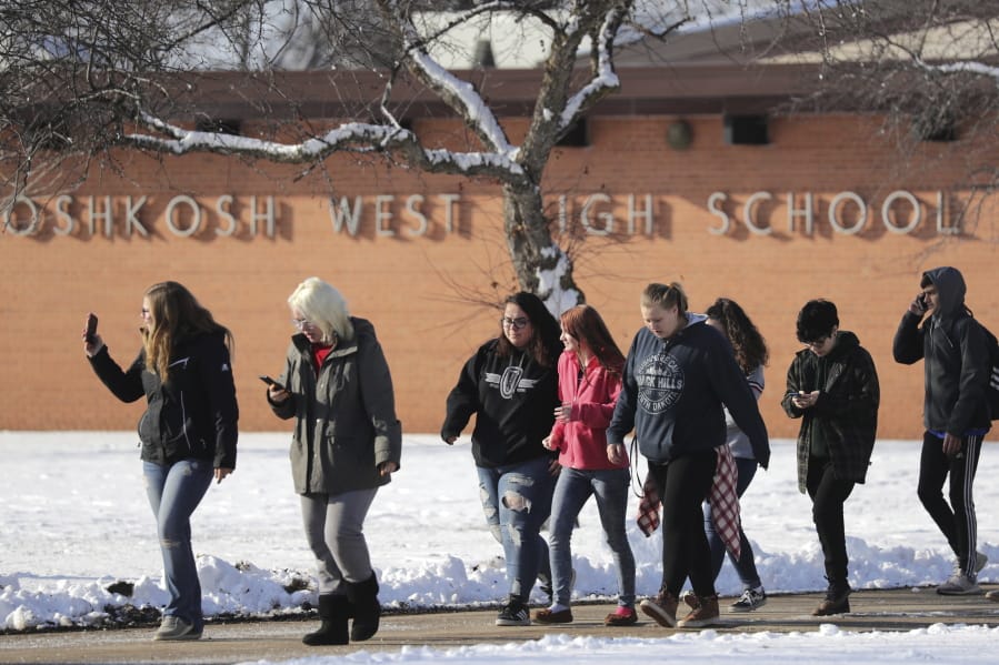 Students are evacuated from the scene of an officer invloved shooting at Oshkosh West High School after an armed student confronted a school resource officer on Tuesday December 3, 2019, at in Oshkosh, Wis. Police in Oshkosh say a police officer and an armed student whom he confronted at the school were both wounded in the confrontation Tuesday morning. (Wm.