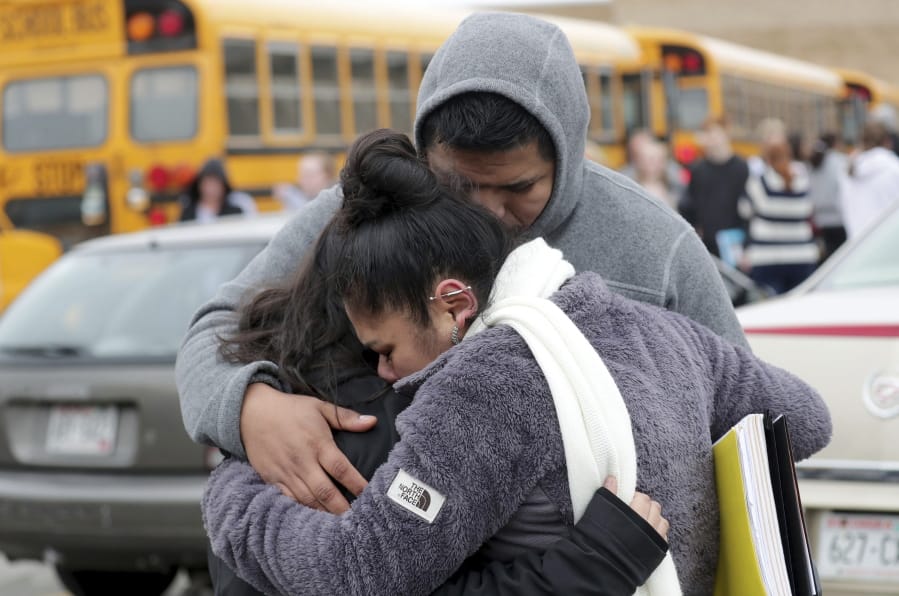Becky Galvan, center, consoles her daughter, Ashley Galvan, a 15-year-old sophomore, with her father Jose Chavez outside Waukesha South High School in Waukesha on Monday, Dec. 2, 2019. Gunshots were exchanged between a student and a school resource officer inside Waukesha South High School, according to school officials.