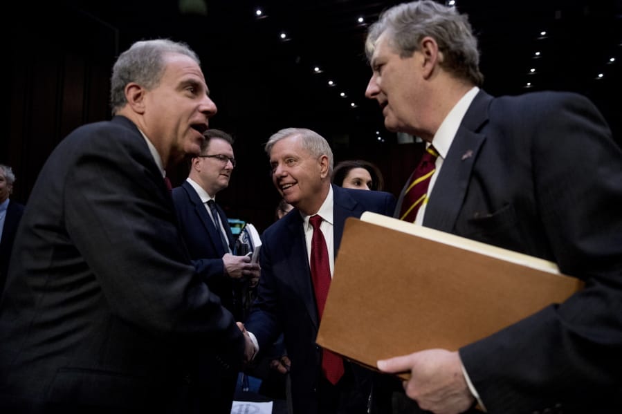 Department of Justice Inspector General Michael Horowitz, left, speaks with Chairman Lindsey Graham, R-S.C., center, and Sen. John Kennedy, R-La., right, after testifying at a Senate Judiciary Committee hearing on the Inspector General&#039;s report on alleged abuses of the Foreign Intelligence Surveillance Act, Wednesday, Dec. 11, 2019, on Capitol Hill in Washington.