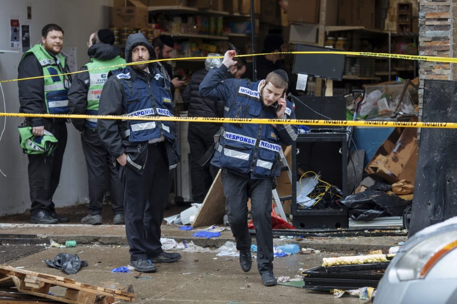 Responders work to clean up the scene of Tuesday&#039;s shooting that left multiple people dead at a kosher market on Wednesday Dec. 11, 2019, in Jersey City, N.J.