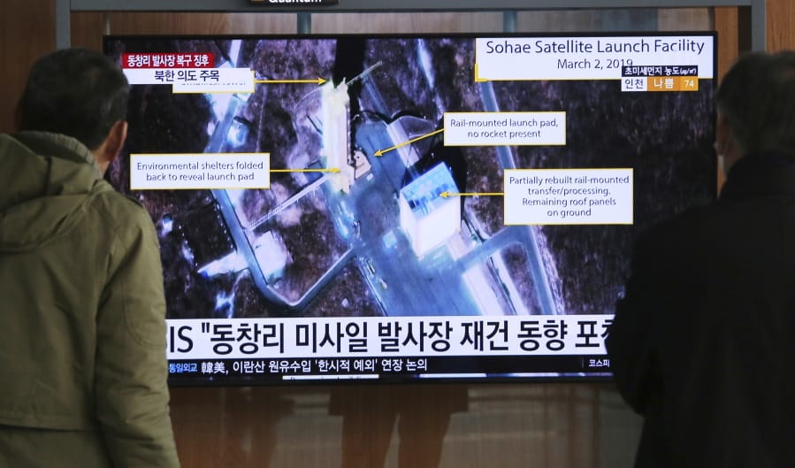 People watch a TV screen March 6 showing an image of the Sohae Satellite Launching Station in Tongchang-ri, North Korea, during a news program at the Seoul Railway Station in Seoul, South Korea.