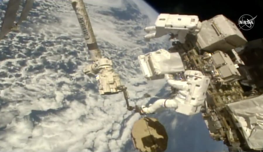 In this image taken from NASA video Italian astronaut Luca Parmitano, lower right, holds a bundle of new pumps for the Alpha Magnetic Spectrometer as he and U.S. astronaut Andrew Morgan work to revitalize a cosmic ray detector outside the International Space Station on Monday, Dec. 2, 2019. Monday&#039;s spacewalk is the third in nearly three weeks for the pair and is the culmination of years of work to repair the Alpha Magnetic Spectrometer.