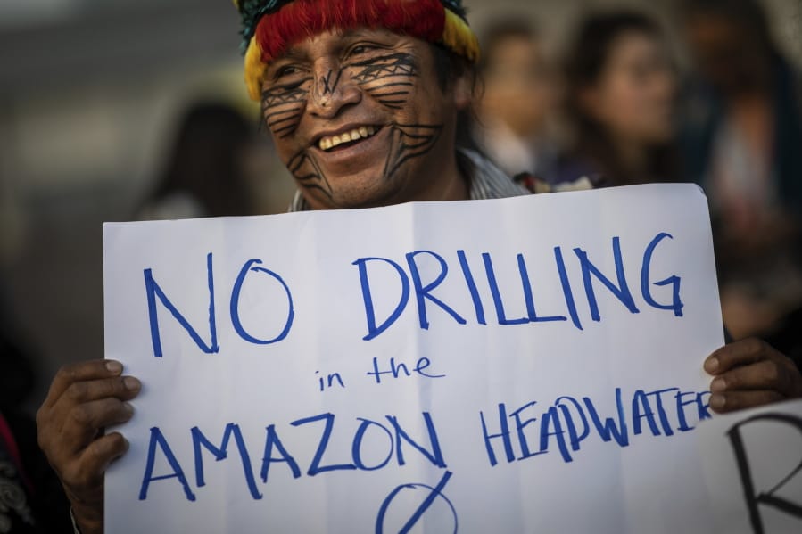 A member of the indigenous people of Ecuador attends a protest at the COP25 summit in Madrid, Wednesday Dec. 11, 2019. World leaders agreed in Paris four years ago to keep global warming below 2 degrees Celsius (3.6 degrees Fahrenheit), ideally no more than 1.5 C (2.7 F) by the end of the century. Scientists say countries will miss both of those goals by a wide margin unless drastic steps are taken to begin cutting greenhouse gas emissions next year. Claiming that the message doesn&#039;t seem to be getting through to governments, over one hundred activists led by representatives of indigenous peoples from Latin and North America made their way to the talks&#039; venue, blocking for some tense minutes the entrance to a plenary meeting where U.N. Secretary General Antonio Guterres was about to speak.