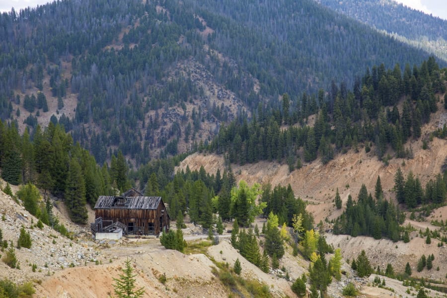 This Sept. 19, 2018 photo shows the last standing building above the Yellow Pine Pit open-pit gold mine in the Stibnite Mining District in central Idaho, where a company hopes to start mining again. Documents show the Trump administration intervening in a U.S. Forest Service decision so that a Canadian company could write a key environmental report on its proposed open-pit gold mines in central Idaho.