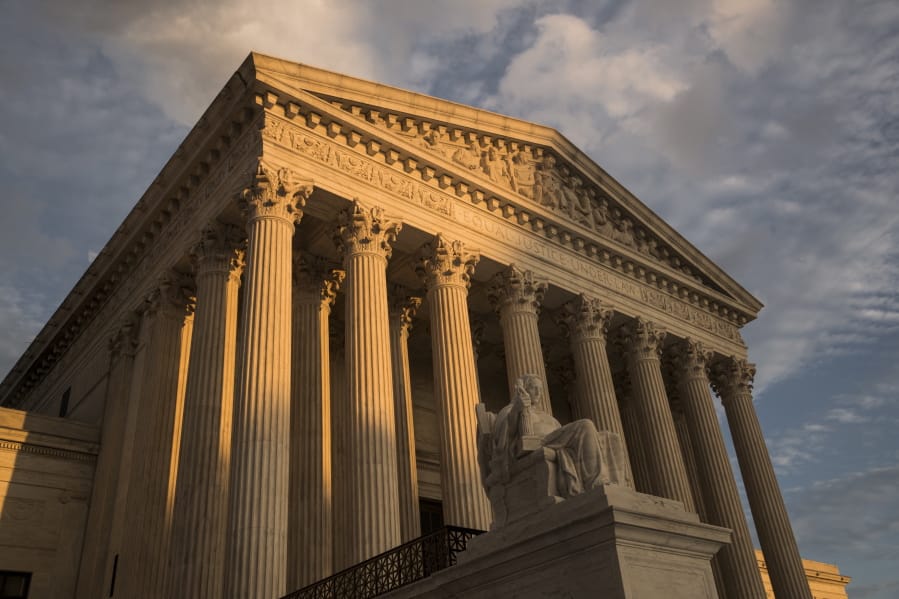 FILE - In this Oct. 10, 2017, file photo, the Supreme Court in Washington, at sunset. The Supreme Court has left in place a Kentucky law requiring doctors to perform ultrasounds and show fetal images to patients before abortions. The justices did not comment on Monday, Dec. 9, 2019, in refusing to review an appeals court ruling that upheld the law. (AP Photo/J.
