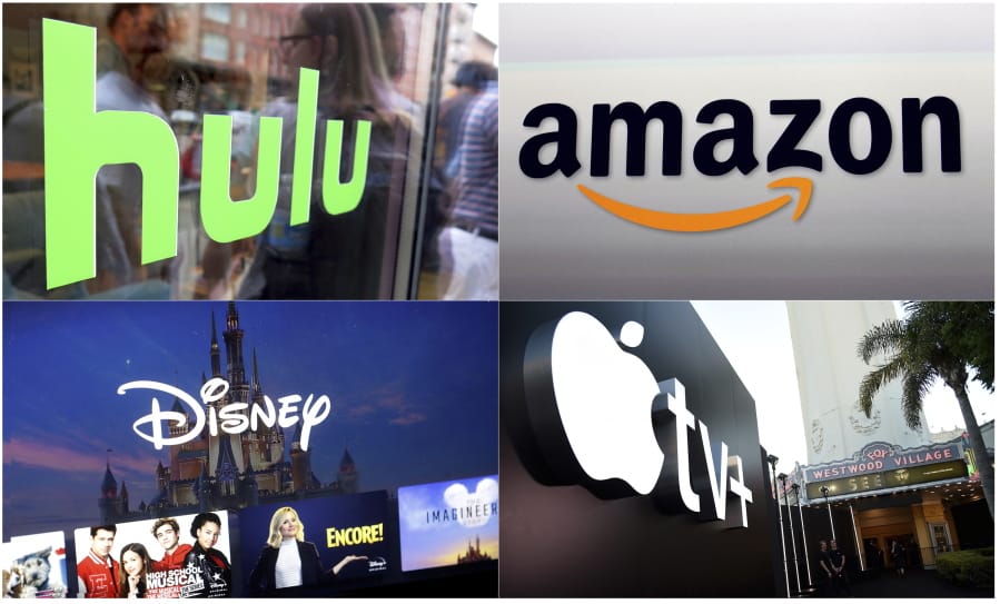 This combination photo shows, clockwise from top left, the Hulu logo on a window at the Milk Studios space in New York, the Amazon logo in Santa Monica, Calif., the Apple TV+ logo displayed outside the Regency Village Theatre in Los Angeles before the premiere of the the Apple TV+ series &quot;See,&quot; and a screen grab of the Disney Plus streaming service on a computer screen.
