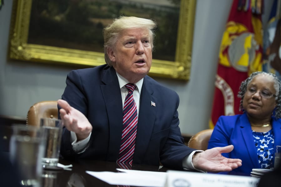 Barb Smith, President, Journey Steel, Inc., right, listens President Donald Trump speaks during a small business roundtable in the Roosevelt Room of the White House, Friday, Dec. 6, 2019, in Washington.