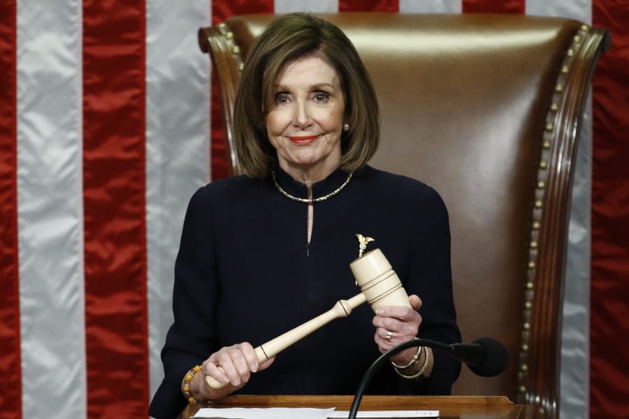 House Speaker Nancy Pelosi of Calif., smiles as she holds the gavel as the House votes on articles of impeachment against President Donald Trump by the House of Representatives at the Capitol in Washington, Wednesday, Dec.