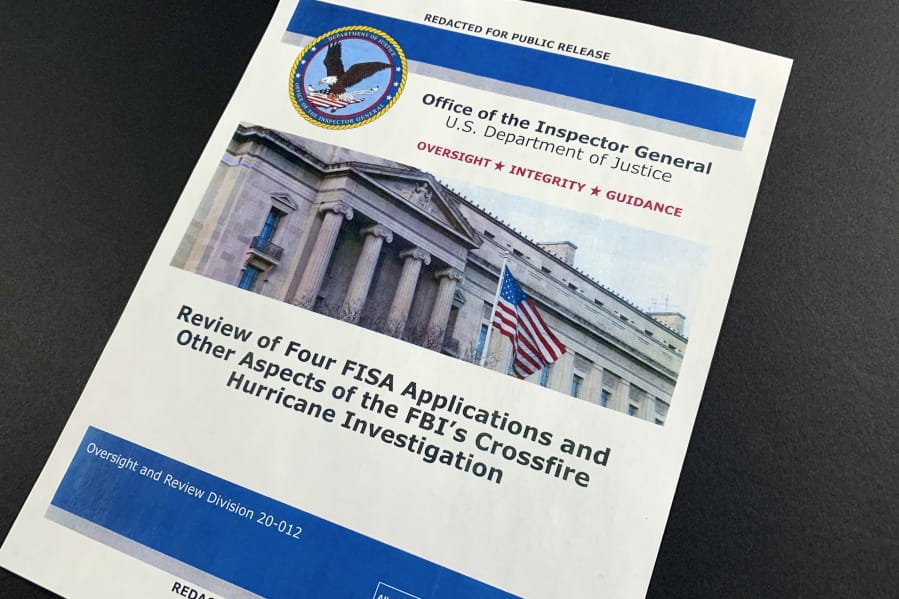 The cover page of the report issued by the Department of Justice inspector general is photographed in Washington, Monday, Dec. 9, 2019. The report on the origins of the Russia probe found no evidence of political bias, despite performance failures.