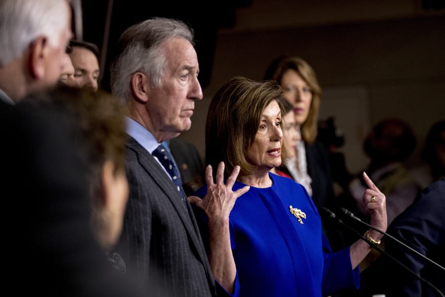 House Speaker Nancy Pelosi of Calif., accompanied by Chairman of the House Ways and Means Committee Richard Neal, D-Mass., left, and other House members, speaks at a news conference to discuss the United States Mexico Canada Agreement (USMCA) trade agreement, Tuesday, Dec. 10, 2019, on Capitol Hill in Washington.