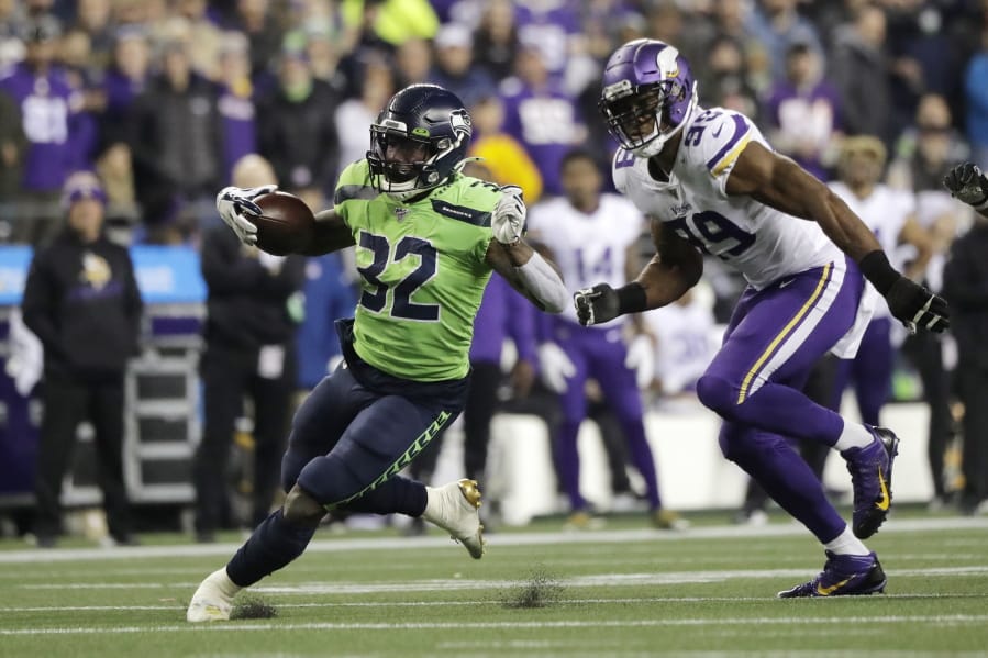 Seattle Seahawks&#039; Chris Carson runs on a 26-yard carry as Minnesota Vikings&#039; Danielle Hunter pursues during the second half of an NFL football game, Monday, Dec. 2, 2019, in Seattle. (AP Photo/Ted S.