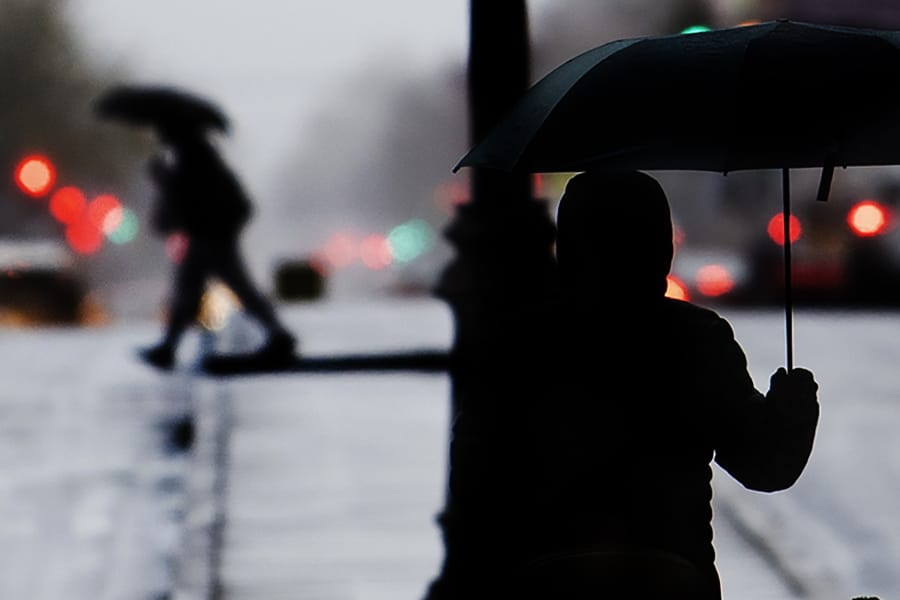 Pedestrians use umbrellas during a rainy day in Center City on Sunday in Philadelphia. (Jose F.