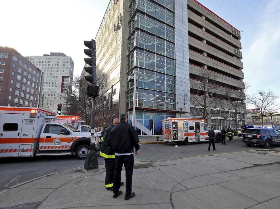 Emergency personnel at the scene of an incident at the Renaissance Park Garage where an adult and 2 children fell from the garage and were found dead on a sidewalk near the Boston parking garage on Christmas Day, Wednesday, Dec. 25, 2019.