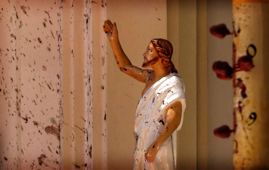 FILE - In this April 21, 2019, file photo, bloodstains a Jesus Christ statue at the St. Sebastian&#039;s Church after a blast in Negombo, north of Colombo, Sri Lanka. On Easter Sunday, April 21, bombs shattered the celebratory services at two Catholic churches and a Protestant church in Sri Lanka.