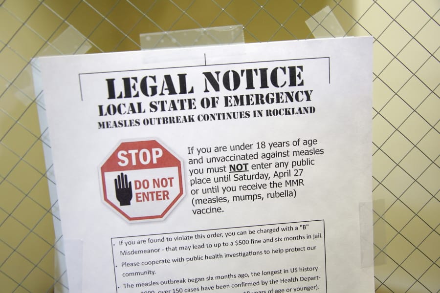 FILE - In this Wednesday, March 27, 2019 file photo, a sign at the Rockland County Health Department in Pomona, N.Y., explains the local state of emergency regarding a measles outbreak. There were nearly 1,300 case of measles in the U.S. through November 2019 - the largest number in 27 years. There were no deaths but about 120 people ended up in the hospital.
