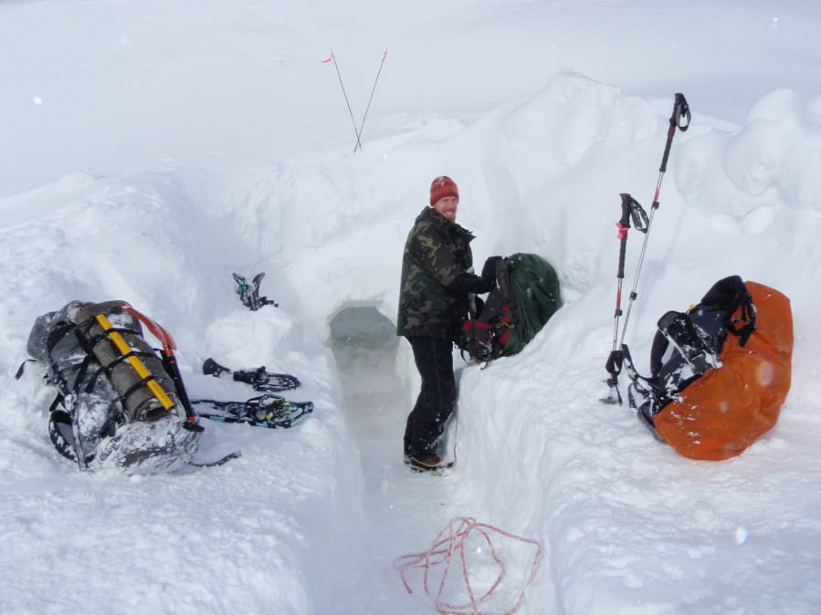 Prepping for a night in a snow cave, Brian Kimble sets about getting his gear in order.  With the snow level at 3,500 to 4,000 feet right now, hikers will have to hit the high elevation areas to camp this way.