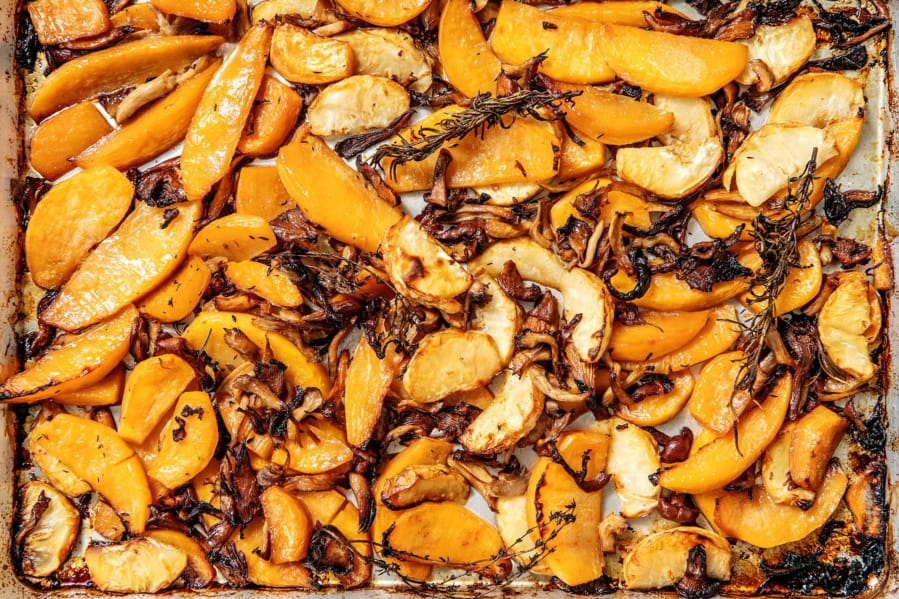 A sheet pan of roasted rutabaga, celery root and mushrooms basted in bacon fat. Prop styling by Nidia Cueva.