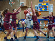 Kelso's Evermore Kaiser goes for a layup as she's swarmed by Prairie defenders during Prairie's 44-29 win in a 3A Greater St. Helens League girls basketball game Thursday in Kelso.