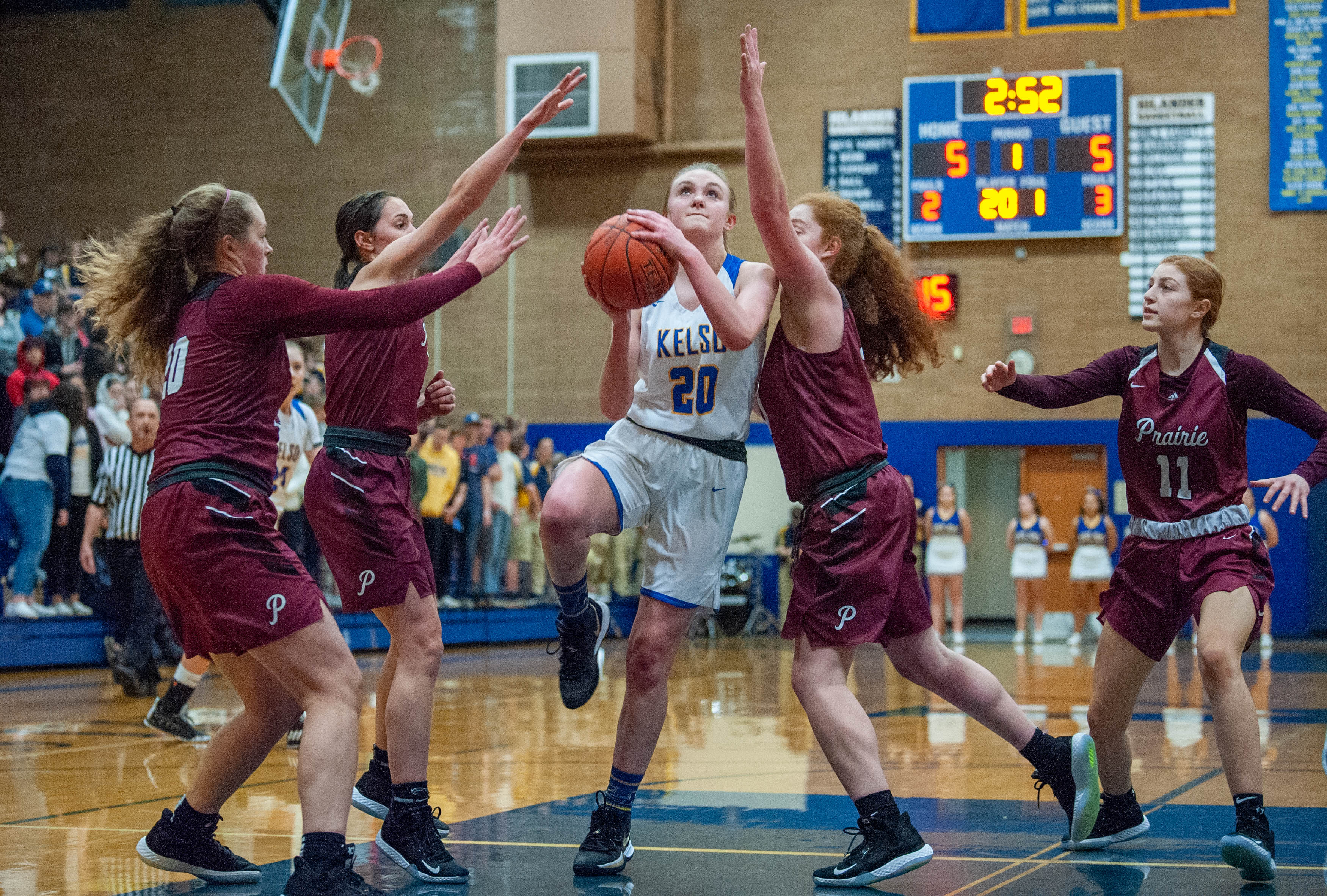 Kelso's Evermore Kaiser goes for a layup as she's swarmed by Prairie defenders during Prairie's 44-29 win in a 3A Greater St. Helens League girls basketball game Thursday in Kelso.