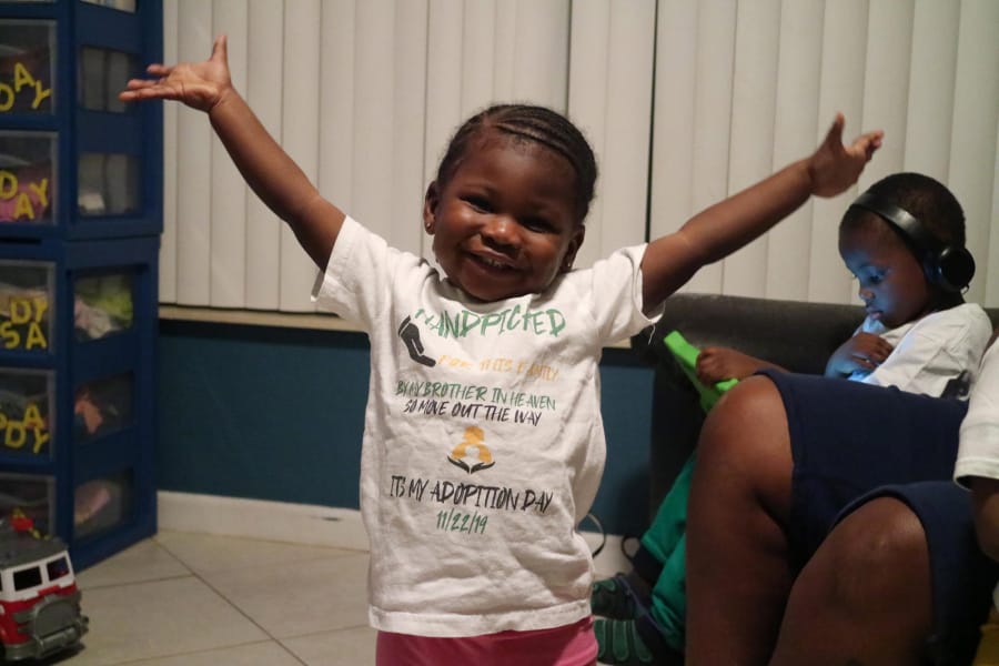 Two-year-old Zariah Senior smiles in her Boynton Beach home on Dec. 9. She is wearing the same shirt she wore on the day she and her siblings were adopted out of foster care by Monica Peoples and Michelle Senior.