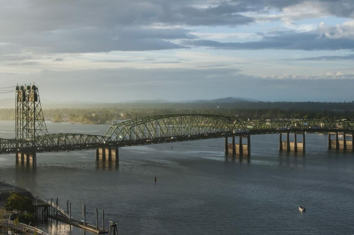 The I-5 Bridge stretches over the Columbia River at sunrise.