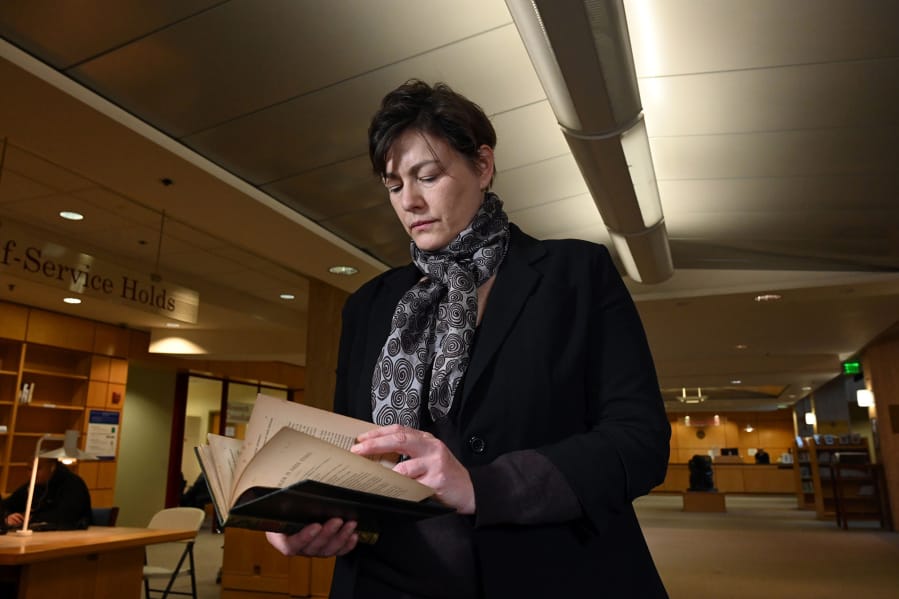 Gabrielle Dean, a curator for rare books and manuscripts at Johns Hopkins University, holds the lost sixth copy of a &quot;A Problem in Greek Ethics&quot; by John Addington Symonds. Dean found the copy of the privately printed book.