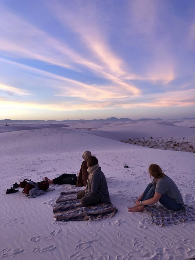 Campers catch the sunset on top of the dunes in White Sands National Park in New Mexico.
