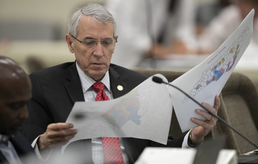 FILE - In this Sept. 12, 2019, file photo, State Rep. John Szoka of Fayetteville, looks over a redistricting map during a committee meeting at the Legislative Office Building in Raleigh, N.C. The reins of political power will be at stake in the 2020 U.S. elections CfO not just for the presidency, but for thousands of low-profile elections for state House and Senate seats.