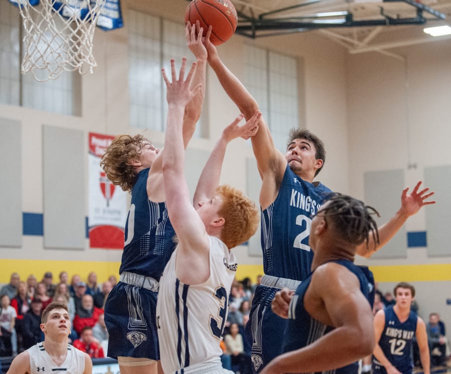 King&#039;s Way Christian&#039;s Justin Frahm, right, grabs a rebound over teammate Bryson Metz and Seton Catholic&#039;s Andrew Olson in the Knights&#039; 75-65 win on Wednesday.