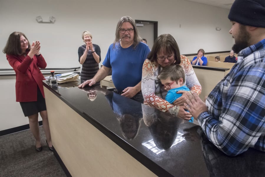 Shelly Krebs, the Bauer&#039;s attorney, from left, Kaine&#039;s Case Worker Jennifer Brinkman, Roddy Bauer, Crystal Bauer, Kaine Jackson Bauer, and Ronald Bauer, the Bauer&#039;s biological son, celebrate in the courtroom following Kaine&#039;s official adoption on Nov. 16, 2018. Crystal said Kaine insisted his name be changed to Michael Jackson following the adoption, but the Bauers convinced him to only change his middle name.
