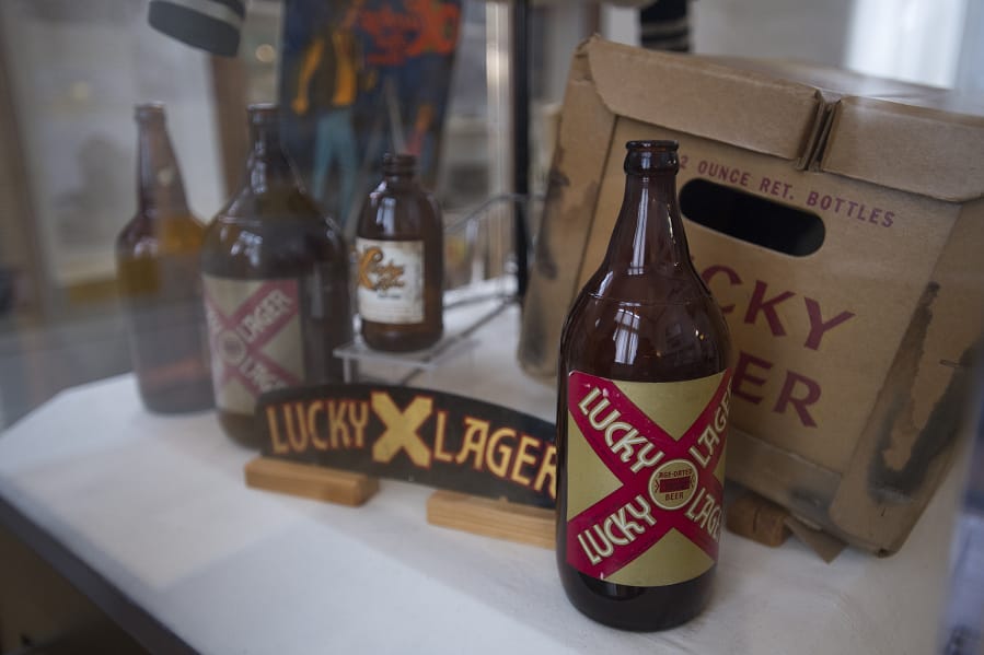 Lucky Lager beer bottles from the 1940s-1980s are seen on display at the new &quot;History A-Brewin&#039; &quot; exhibit on Friday afternoon.