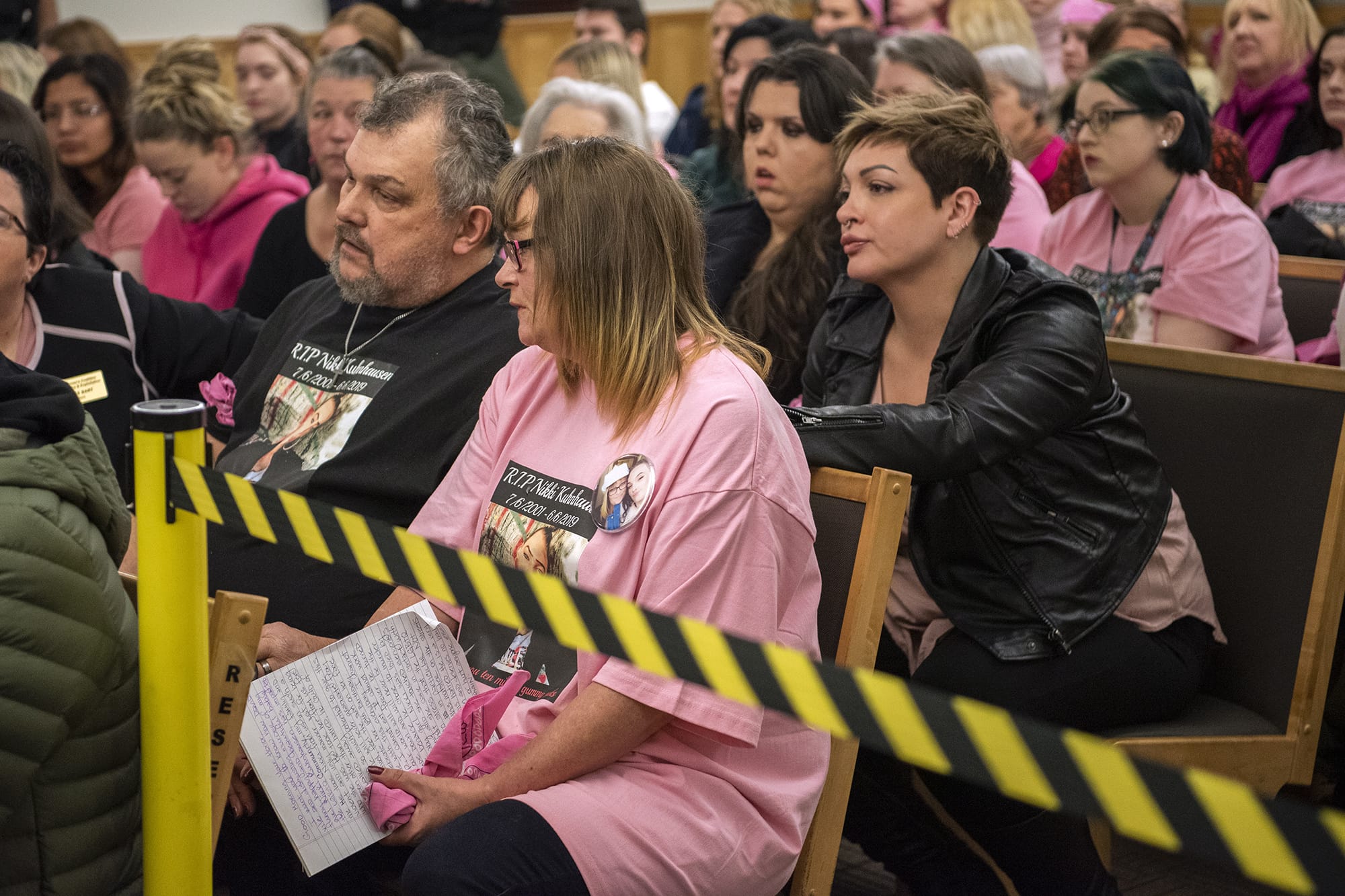 Nikki Kuhnhausen's stepfather Vincent Woods, left, and mother Lisa Woods, right, listen to the judge during the bail review hearing for David Y. Bogdanov at Clark County Superior Court on Thursday morning, Jan. 2, 2020. Judge David Gregerson set $750,000 bail Thursday for Bogdanov, the suspect in the slaying of a transgender Vancouver teen Nikki Kuhnhausen. Transgender activist and advocate Devon Rose Davis, right, comforts Lisa Woods.