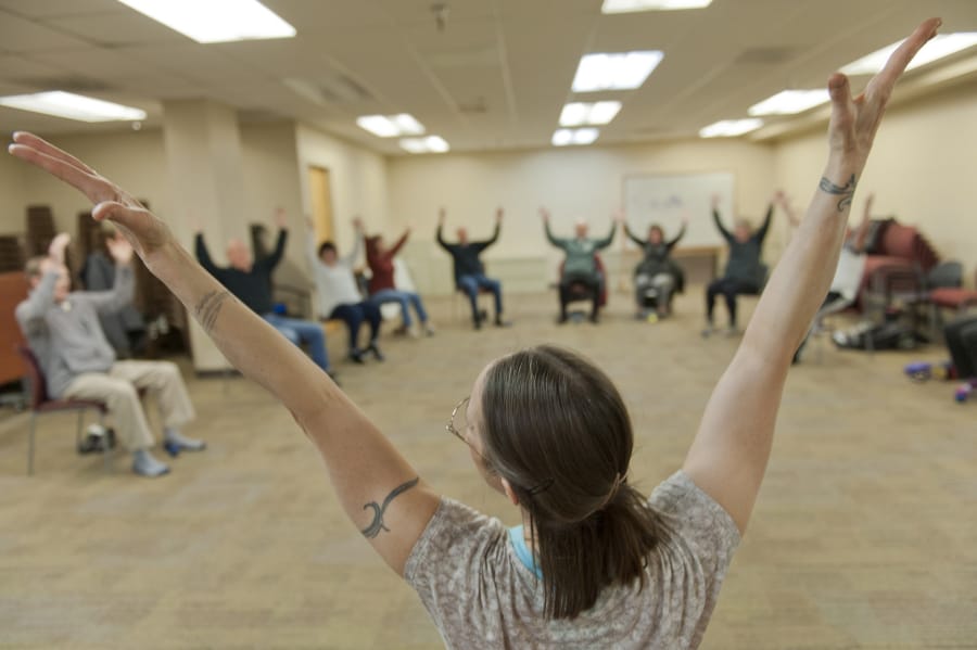 Laura Lou Pape-McCarthy leads a movement class to help patients with Parkinson&#039;s disease prevent falls, improve speech and facial expressions, and find a sense of community. Pape-McCarthy leads the class in upper body and vocal stretches. The class is offered through Parkinson&#039;s Resources of Oregon.