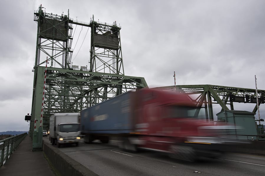 Trucks cross the Interstate 5 Bridge while traveling north on Tuesday morning.