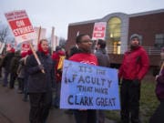 Christina Smith, who is an English professor, with blue sign, joins colleagues while striking at Clark College on Monday morning, Jan. 13, 2020.
