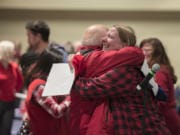 Clark College professor Michelle Roth, in plaid, hugs a colleague after the result of the union vote at Gaiser Hall on Wednesday. The union voted to ratify its new contract 257-9, drawing a three-day teacher strike to a close.