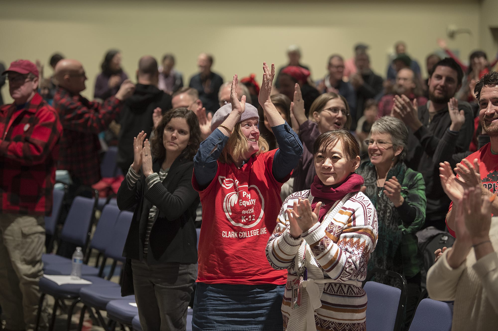 Members of the Clark College Association for Higher Education react with a standing ovation after the union vote was announced at Gaiser Hall on Wednesday afternoon, Jan. 15, 2020. The contract was ratified 257-9.