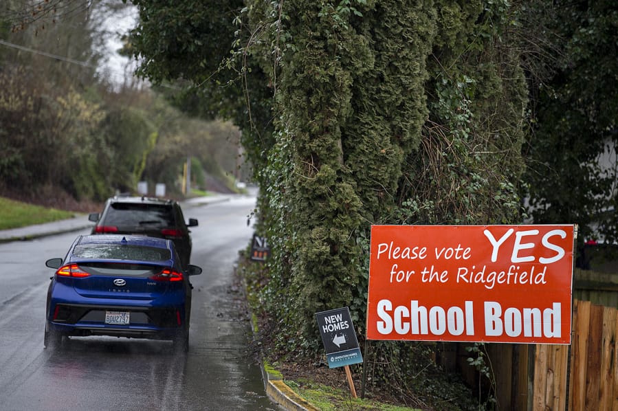 Motorists traveling on South Hillhurst Road pass a sign advertising the upcoming Ridgefield school bond Thursday afternoon. The district is asking voters to approve a $107 million bond that would build new schools and improve existing campuses.