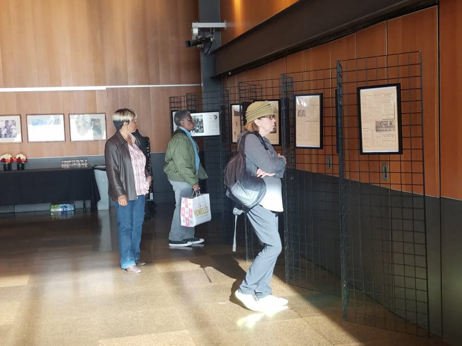 Attendees take in an exhibit honoring the history of African Americans in Clark County, part of an event to kick off a commemoration of Black History Month, on Saturday at the Vancouver Community Library.