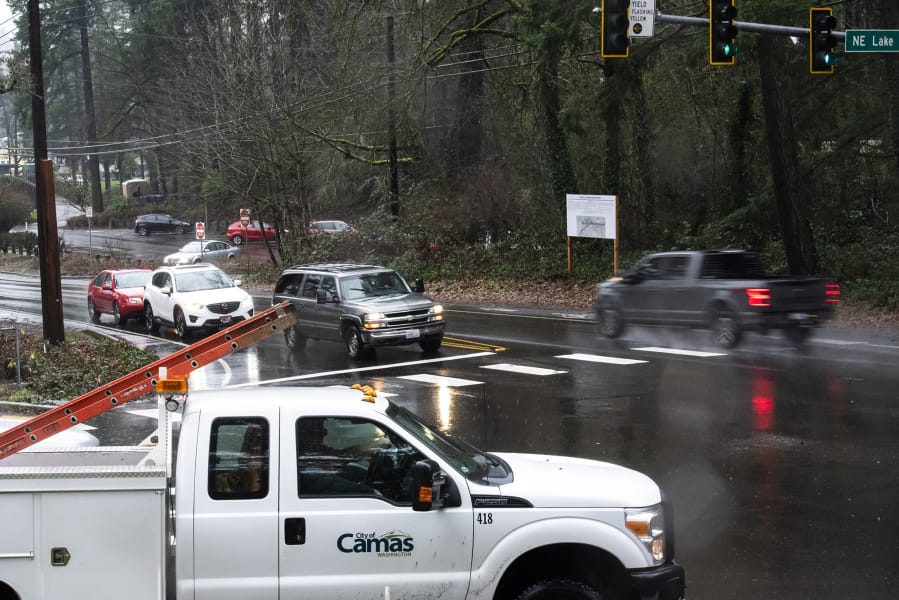 Cars pass through the intersection of Northeast Everett Street and Northeast Lake Road in Camas on Thursday at the site of a roundabout.