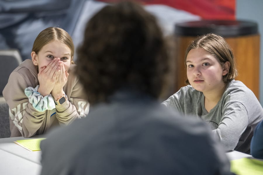 Madelyn Grimes, 11, left, and Melorah Crichton, 11, listen to Jeff Causey, a sixth-grade counselor at Discovery Middle School, during a social and emotional learning session on Monday.