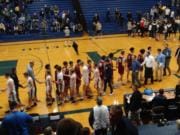 The Prairie and Kelso boys basketball teams shake hands after Prairie's 67-41 win on Tuesday in Kelso.