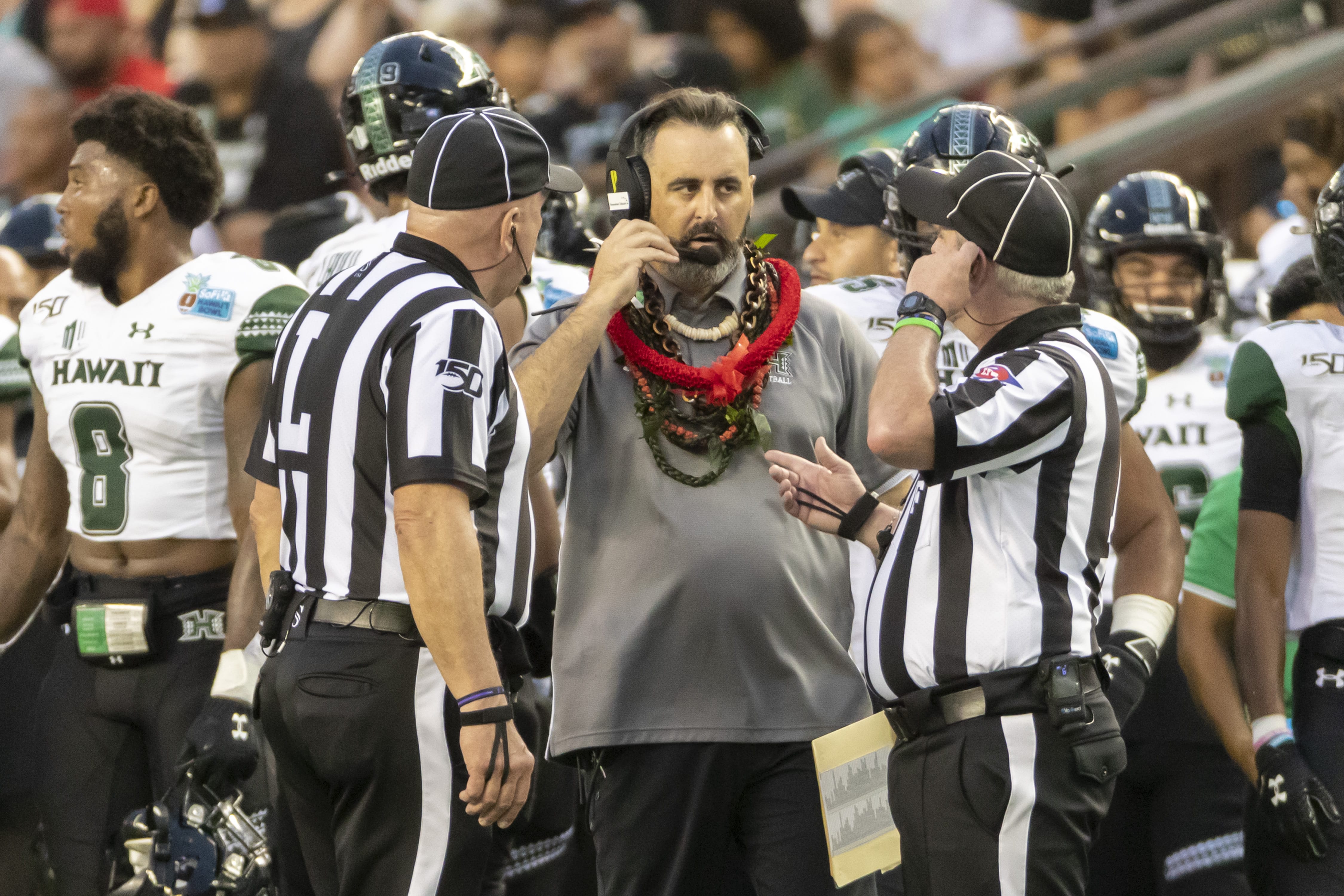Hawaii head coach Nick Rolovich, center, speaks with the game officials in the second half of the Hawaii Bowl NCAA college football game, Tuesday, Dec. 24, 2019, in Honolulu.
