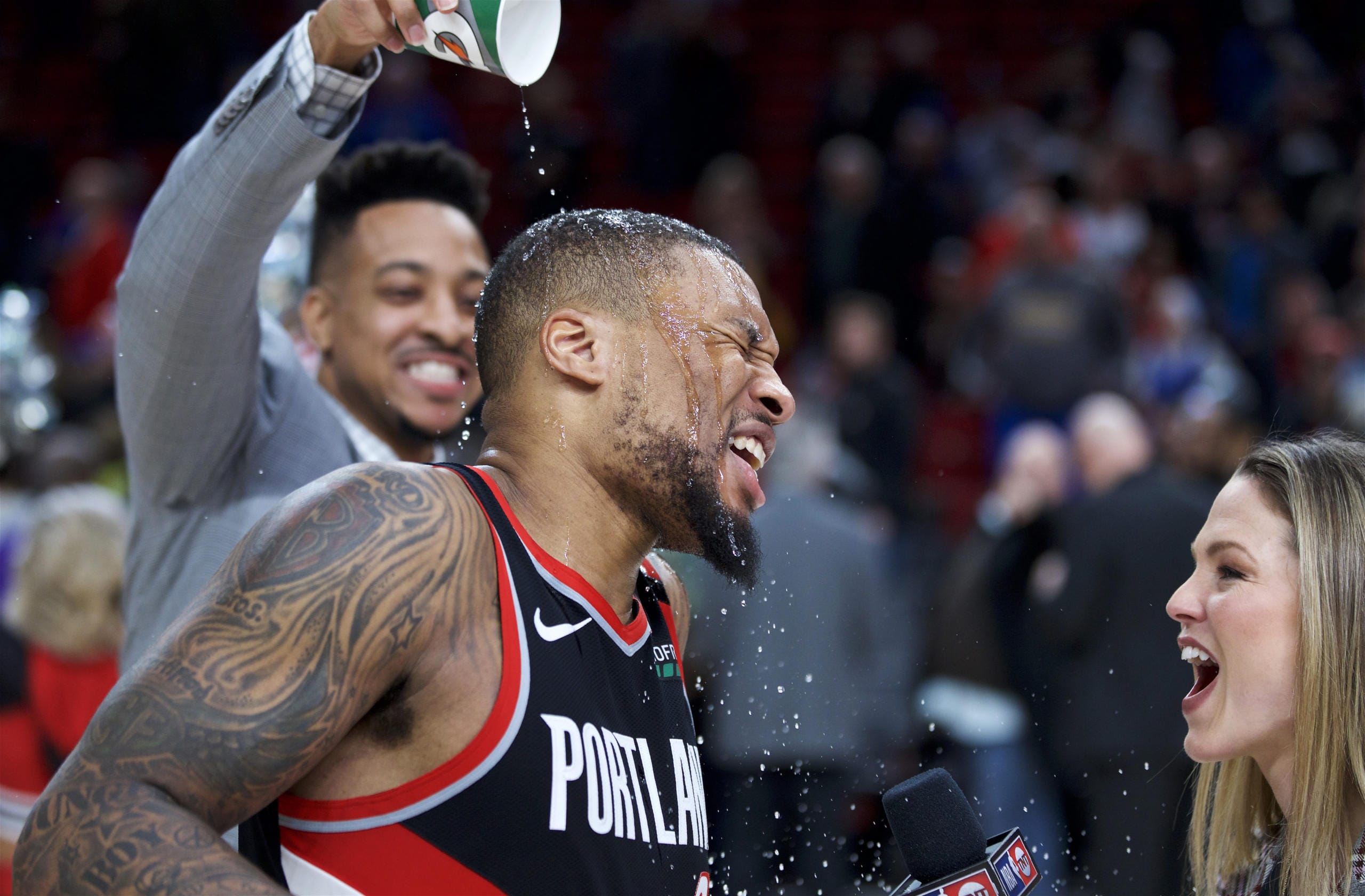 Portland Trail Blazers guard Damian Lillard, center, gets doused by guard CJ McCollum after Lillard scored 61 points against the Golden State Warriors in an NBA basketball game in Portland, Ore., Monday, Jan. 20, 2020. The Trail Blazers won 129-124 in overtime.