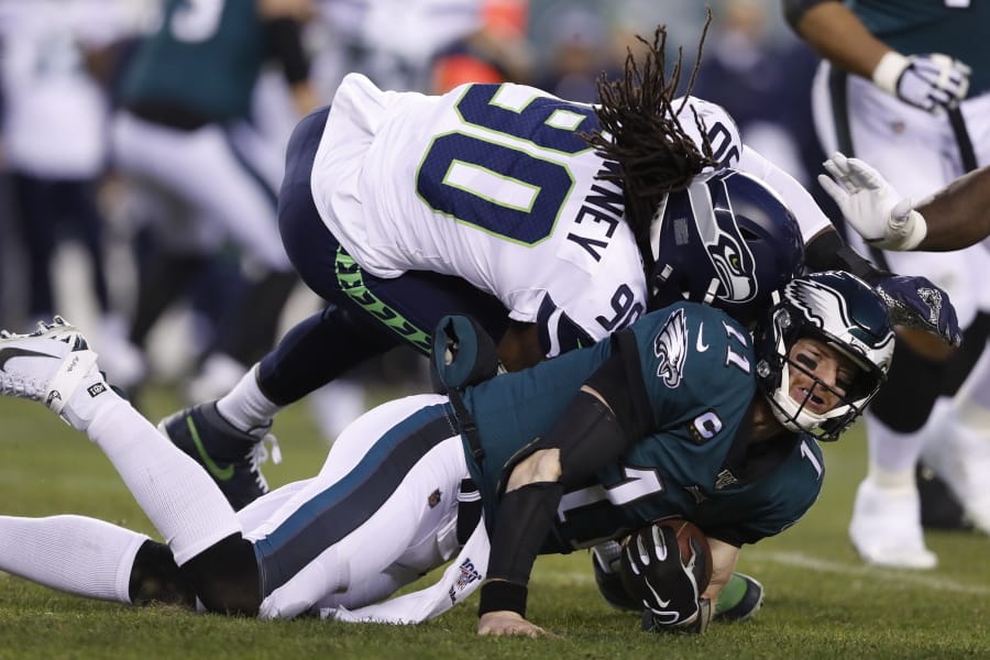 Seattle Seahawks&#039; Jadeveon Clowney (90) hits Philadelphia Eagles&#039; Carson Wentz (11) during the first half of an NFL wild-card playoff football game, Sunday, Jan. 5, 2020, in Philadelphia. Wentz was injured on the play.