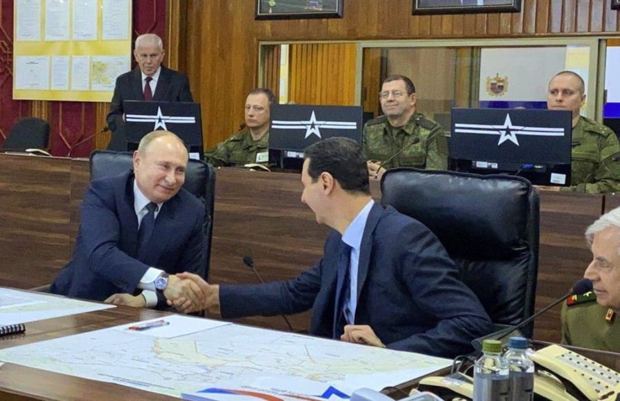This image released by the Syrian Presidency shows Russian President Vladimir Putin, left, meeting with Syrian President Bashar Assad, center, in Damascus, Syria on Tuesday, Jan. 7, 2020. Putin&#039;s visit is the second to the war-torn country where his troops have been fighting alongside Syrian government forces since 2015.