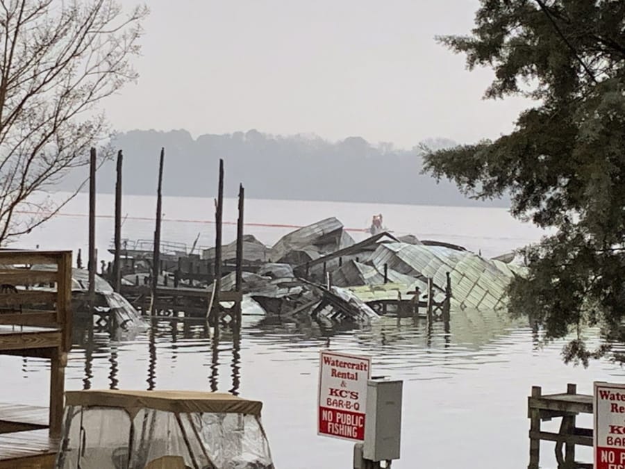 The remains of a dock where at least 35 vessels, many of them houseboats, were destroyed by fire early Monday, Jan. 27, 2020, in Scottsboro, Ala. Scottsboro Fire Chief Gene Necklaus is confirming fatalities in a massive fire at a boat dock.