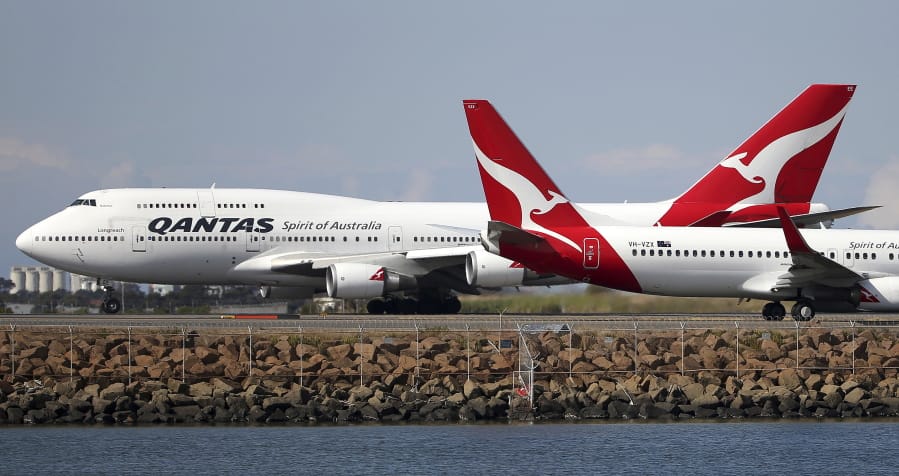 FILE - In this Aug. 20, 2015 file photo, two Qantas planes taxi on the runway at Sydney Airport in Sydney, Australia. Some Asian airlines have rerouted flights to the Middle East to avoid Iranian airspace, amid escalated tensions over the United States&#039; assassination of a prominent Iranian commander in Iraq.