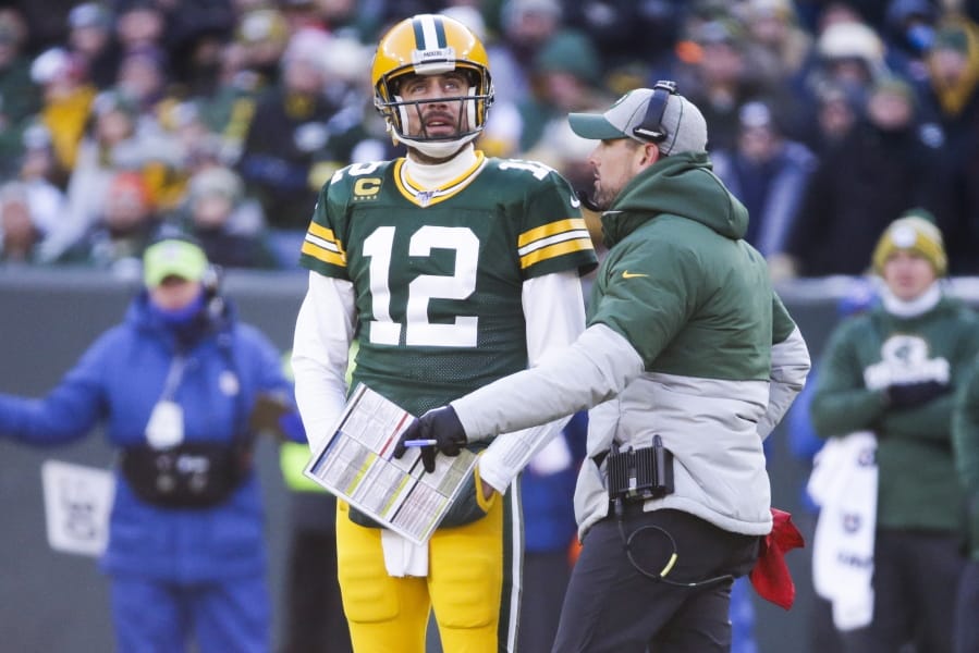 Green Bay Packers head coach Matt LaFleur talks to Aaron Rodgers during the first half of an NFL football game against the Chicago Bears Sunday, Dec. 15, 2019, in Green Bay, Wis.