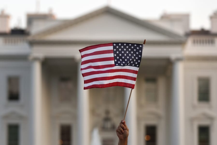 FILE - In this Sept. 2017 file photo, a flag is waved outside the White House, in Washington. The Trump administration is coming out with new visa restrictions aimed at restricting a practice known as &quot;birth tourism.&quot; That refers to cases when women travel to the United States to give birth so their children can have U.S. citizenship.